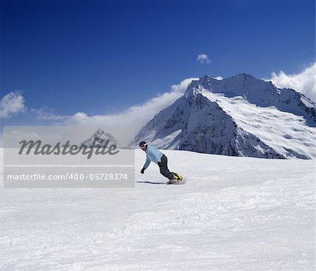 Snowboarder descends a slope. Caucasus Mountains