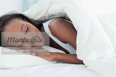 Happy woman sleeping in her bedroom