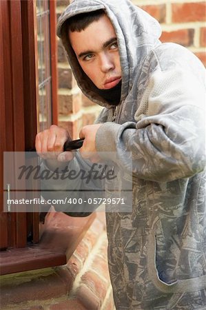 Young Man Breaking Into House