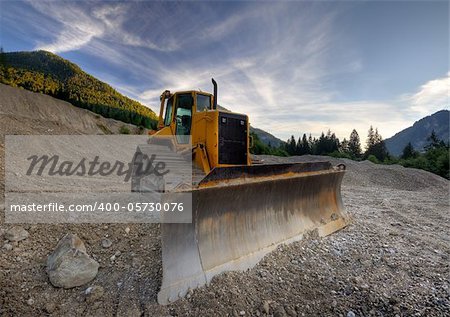 Bulldozer in the mountains at a stone quarry