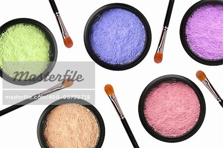colorful cosmetics eyeshadows in box and brushes isolated on white