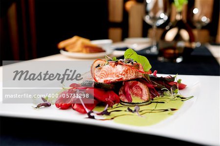 Smoked trout with vegetables on a plate