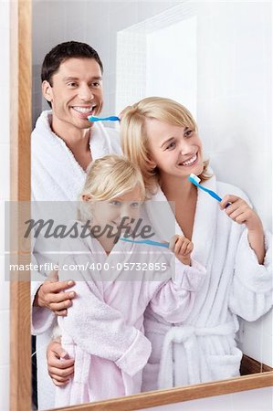 Family brushing their teeth in the bathroom