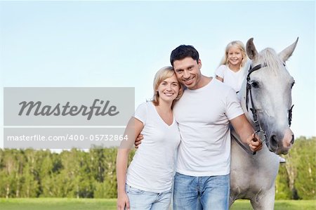 Parents and child with a horse