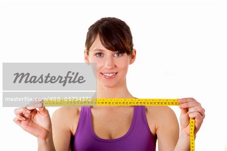 Athletic young woman holding a measuring tape - Healthy body concept