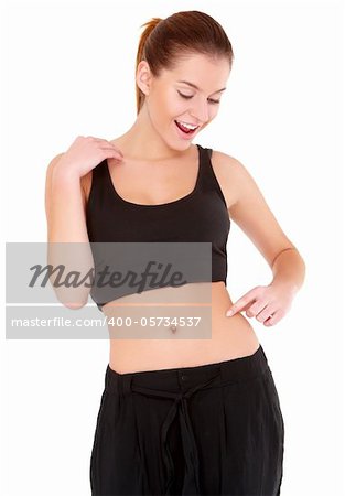 Happy woman checks the waist fatness on white