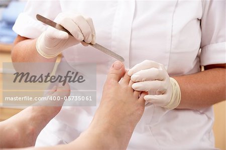 Chirpodist treating client in clinic