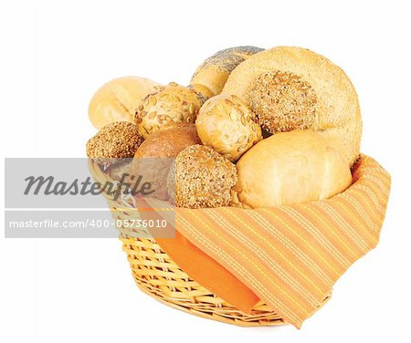 Assortment of baked bread in a basket on white background