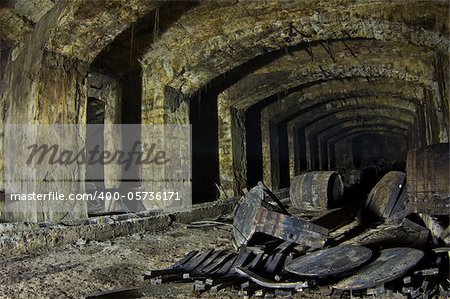 Destroyed barrels in an abandoned cellar.