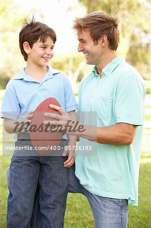 Father And Son Playing American Football Together