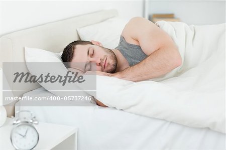 Serene man sleeping in his bedroom