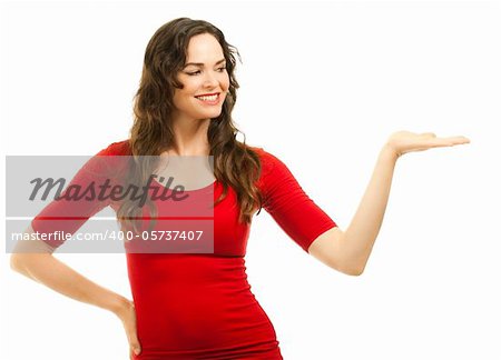 Isolated portrait of a beautiful young smiling woman showing with hand and looking at copyspace