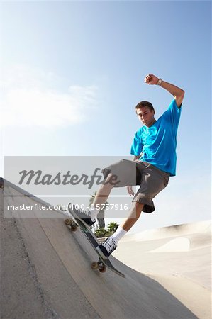 Teenage Boy In Skateboard Park