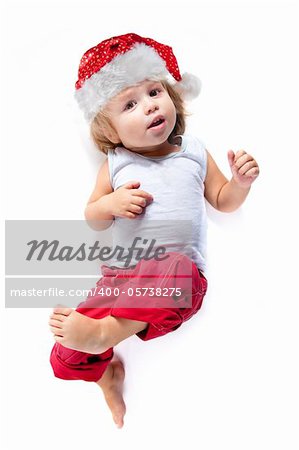 Cute little Santa helper in red pants, high angle view, isolated on white background