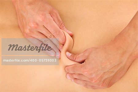 A picture of male hands giving a back massage over white background
