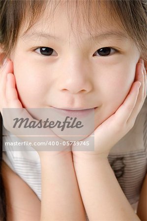 Close-up shot of a young Asian girl with smile on her face.