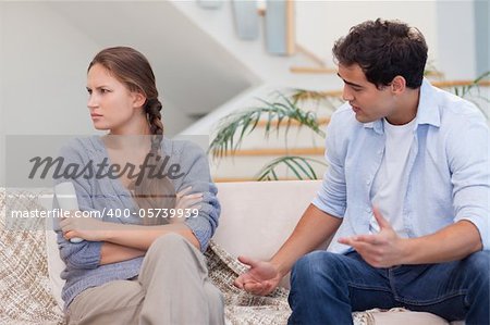 Man arguing with his wife in their living room