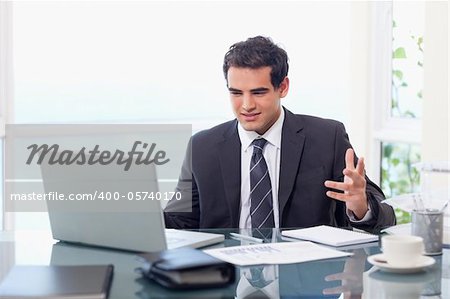Upset businessman working in his office
