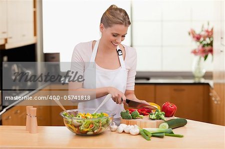 Woman slicing vegetables in her kitchen