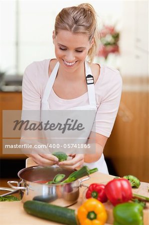 Portrait of a young woman cooking in her kitchen