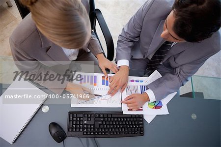 Serisous business team studying statistics in a meeting room