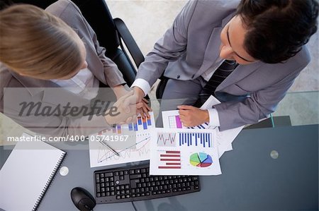 Business team agreeing on a deal in a meeting room