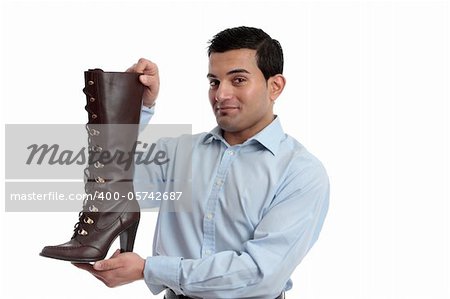 Smiling retail salesman holding or showing off a ladies leather boot.