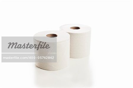 Rolls of toilet paper arranged on white background