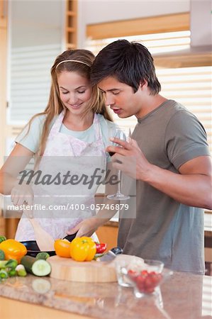 Portrait of a couple cooking while drinking wine in their kitchen