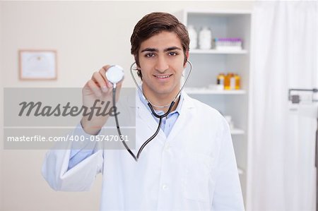 Young male doctor using stethoscope