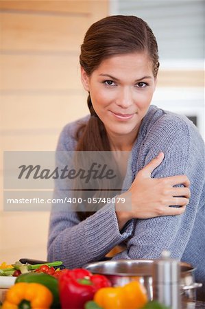 Young woman leaning against the kitchen counter