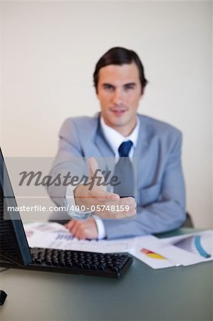 Hand being offered by sitting businessman