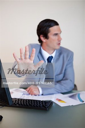 Hand used by businessman to reject something