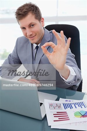 Businessman sitting at his desk giving his approval
