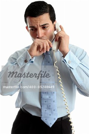 A very worried or anxious businessman or other professional on the phone.  White background.