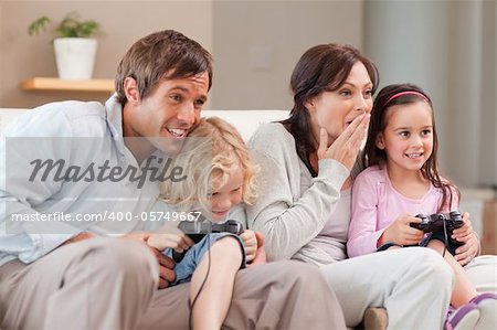 Competitive family playing video games in a living room