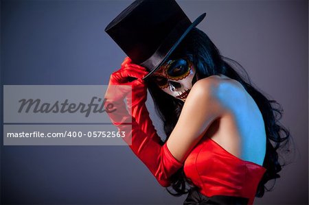 Sugar skull girl in tophat, studio shot