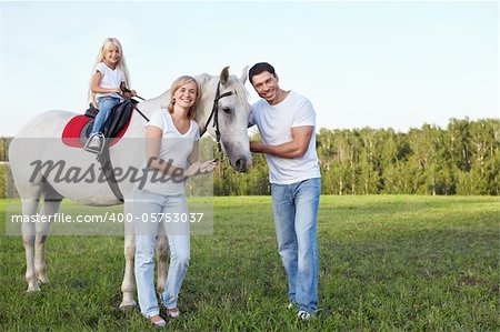 Family with a child on a horse