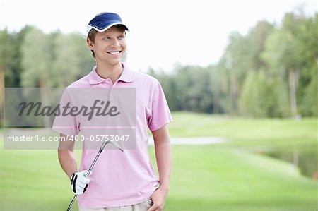 Man with golf club outdoors