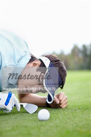 A young man playing golf