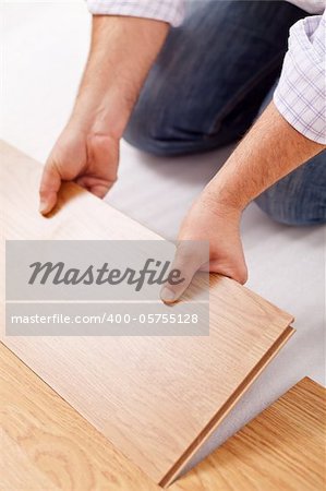 Home improvement - installing laminate flooring, fitting a plank