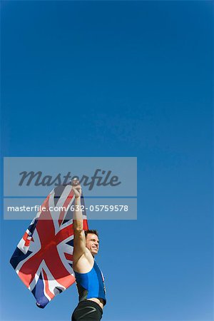 Male athlete holding up British flag