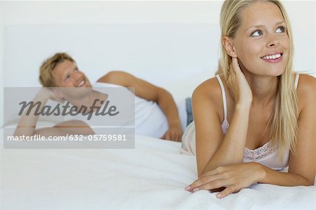 Couple relaxing on bed