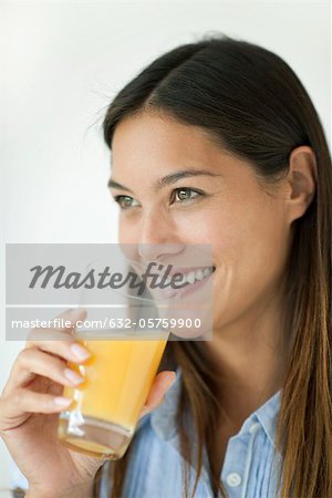 Young woman drinking orange juice