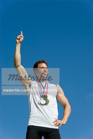 Male athlete with hand raised in victory