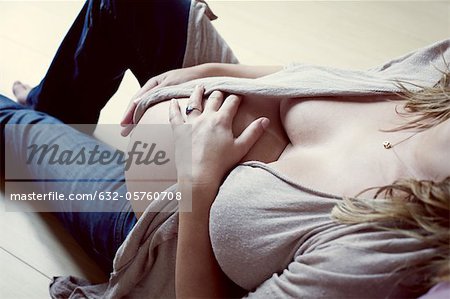 Pregnant woman caressing abdomen, mid section, high angle view
