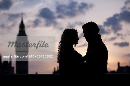 UK, London, Silhouette of couple embracing at sunset
