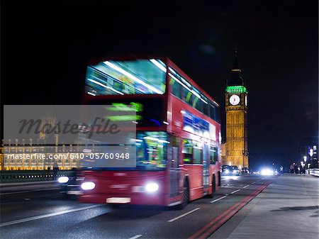 UK, London, Double decker bus driving at night