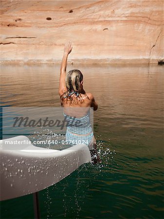 USA, Utah, Woman splashing in Lake Powell