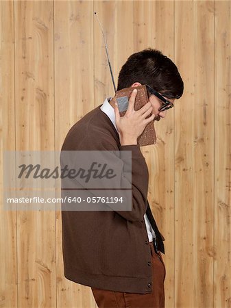 Businessman using brick mobile phone in office